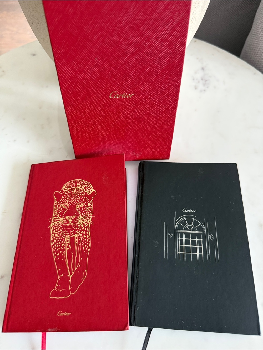 Cartier Red and Black Hardcover Notebooks with Gold Accents